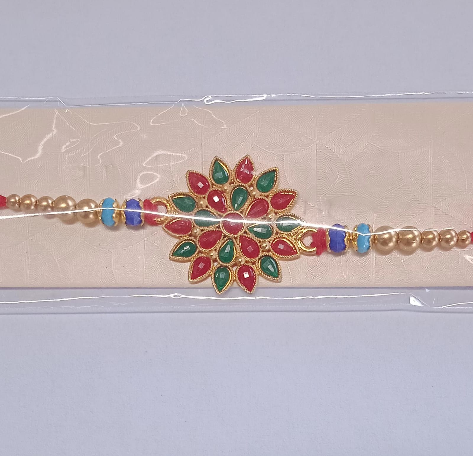Red And Green Colored Stone Flower Design Rakhi Red And Green Colored Stone Flower Design Rakhi
